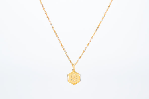 Initial necklace. Engrave your initial in uppercase font on a hexagon shape charm. Crafted onto our Singapore chain necklace. Chain Length: 45cm. Pendant size 1.4cm. Dainty jewelry aesthetic.