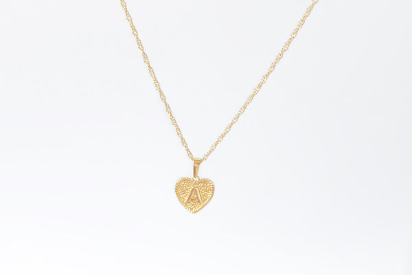 Initial necklace. Engrave your initial in uppercase font on a heart shape charm with intricate detailing. Crafted onto our Singapore chain necklace. Chain Length: 45cm. Pendant size 1.5cm. Made with stainless steel, plated with 18K Gold. Chunky jewelry aesthetic, perfect gift for her / best friend jewelry / best friend gifts